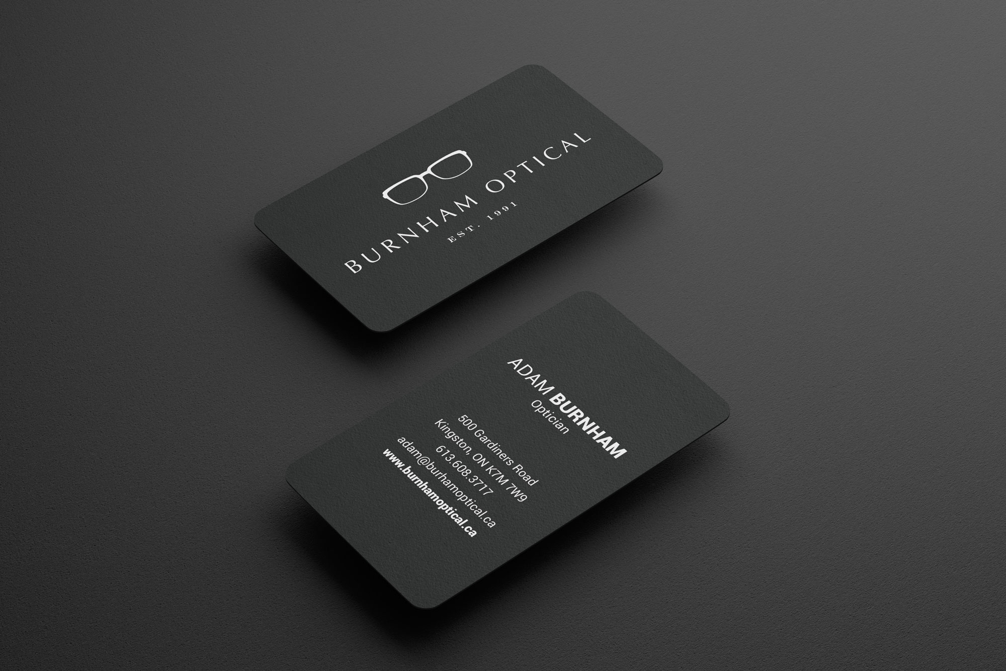an image of business cards designed for burnham optical