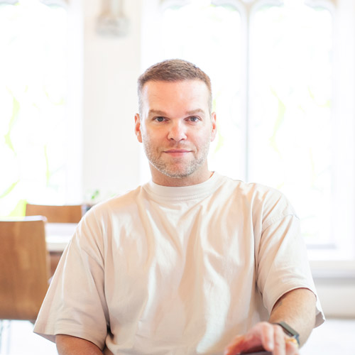 dave mcgregor sitting smiling into the camera